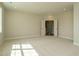 Spacious bedroom boasts recessed lighting and neutral carpeting leading to an adjacent room at 737 W Holly Springs Rd, Holly Springs, NC 27540