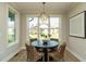Cozy breakfast nook with a round table, wicker chairs, and view of backyard at 737 W Holly Springs Rd, Holly Springs, NC 27540