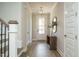 Bright entryway featuring hardwood floors, a decorative light fixture, and a staircase at 737 W Holly Springs Rd, Holly Springs, NC 27540
