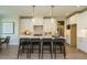 Stylish kitchen featuring a spacious island with seating, pendant lighting, and modern appliances at 737 W Holly Springs Rd, Holly Springs, NC 27540