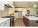 Bright kitchen featuring white cabinets, stainless steel appliances, and an island with light-wood accents at 737 W Holly Springs Rd, Holly Springs, NC 27540