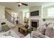 Inviting living room features a fireplace, plush seating, and a view of staircase at 737 W Holly Springs Rd, Holly Springs, NC 27540
