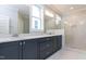 Bathroom featuring a double sink vanity, granite countertops, and a glass-enclosed shower at 743 W Holly Springs Rd, Holly Springs, NC 27540