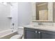 Cozy bathroom featuring a shower-tub, storage vanity and bright lighting at 743 W Holly Springs Rd, Holly Springs, NC 27540