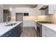 Modern kitchen featuring an island, bright white cabinets, and stainless steel appliances at 743 W Holly Springs Rd, Holly Springs, NC 27540