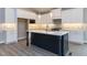 A spacious kitchen with a center island, and stainless steel appliances at 743 W Holly Springs Rd, Holly Springs, NC 27540
