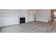 Open-concept living room featuring fireplace and built-in shelving at 743 W Holly Springs Rd, Holly Springs, NC 27540