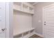 Functional mudroom with bench, cubbies, and door to the outside at 743 W Holly Springs Rd, Holly Springs, NC 27540