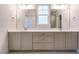 The bright bathroom features a double sink vanity, neutral color palette, and large mirror at 749 W Holly Springs Rd, Holly Springs, NC 27540