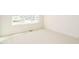 The bright bedroom features large window, neutral color palette, and plush carpet at 749 W Holly Springs Rd, Holly Springs, NC 27540