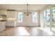 Bright dining area features modern chandelier, built-in cabinetry, and sliding door access to deck at 749 W Holly Springs Rd, Holly Springs, NC 27540