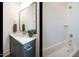 Cozy bathroom with subway tiles, a modern vanity, and a decorative mirror at 755 W Holly Springs Rd, Holly Springs, NC 27540