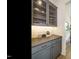 Chic butler's pantry with ample storage, granite countertop and a stylish backsplash at 755 W Holly Springs Rd, Holly Springs, NC 27540