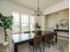 Spacious dining area with a large window, modern chandelier, and stylish table setting at 755 W Holly Springs Rd, Holly Springs, NC 27540