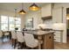 Well-lit kitchen featuring a center island, modern pendant lights, and stainless steel appliances at 755 W Holly Springs Rd, Holly Springs, NC 27540