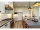 Kitchen with stainless steel gas range and a central island with a sink at 755 W Holly Springs Rd, Holly Springs, NC 27540
