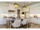 This kitchen features a large center island and white cabinets with black hardware at 755 W Holly Springs Rd, Holly Springs, NC 27540