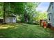 View of a grassy backyard featuring a shed and deck at 8009 Tobin Pl, Raleigh, NC 27612