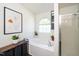 Serene bathroom showcasing a soaking tub, natural light from an arched window, and a glass-enclosed shower at 8009 Tobin Pl, Raleigh, NC 27612