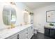 Elegant bathroom featuring double sinks with gold fixtures, marble countertops, and a modern aesthetic at 8009 Tobin Pl, Raleigh, NC 27612