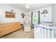 Adorable Bedroom featuring a crib, accent chair, neutral paint, and natural light at 8009 Tobin Pl, Raleigh, NC 27612