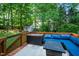 Outdoor deck area with seating and a shed in a wooded backyard at 8009 Tobin Pl, Raleigh, NC 27612