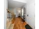 Bright foyer with hardwood floors and stairs leading upstairs, and an adjacent closet space at 8009 Tobin Pl, Raleigh, NC 27612