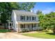 Charming two-story home with a welcoming front porch and beautifully landscaped front yard at 8009 Tobin Pl, Raleigh, NC 27612