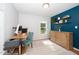 Functional home office with a wooden desk, ample natural light, and calming blue accent wall at 8009 Tobin Pl, Raleigh, NC 27612