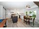 Bright kitchen with white cabinets, granite countertops, and a center island with butcher block countertop at 8009 Tobin Pl, Raleigh, NC 27612