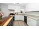 Modern kitchen featuring stainless steel appliances, granite countertops, and white cabinets at 8009 Tobin Pl, Raleigh, NC 27612