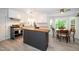 Bright kitchen with a large island, stainless steel appliances, light cabinets, and adjacent breakfast nook at 8009 Tobin Pl, Raleigh, NC 27612