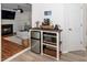 Charming kitchenette with stainless steel mini fridge, microwave, and coffee bar is adjacent to a cozy living space at 8009 Tobin Pl, Raleigh, NC 27612