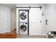 Convenient laundry closet with stacked washer and dryer units and a stylish sliding barn door at 8009 Tobin Pl, Raleigh, NC 27612