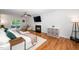 Cozy living room with hardwood floors, fireplace, and sliding glass doors leading to outdoor patio at 8009 Tobin Pl, Raleigh, NC 27612