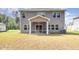 Back exterior showcasing a screened-in porch and well-maintained lawn, creating an inviting outdoor area at 8013 Toddwick Ct, Raleigh, NC 27616
