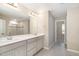 Bright bathroom featuring double vanity sinks, and a spacious shower with glass doors at 8013 Toddwick Ct, Raleigh, NC 27616
