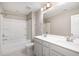 Bright bathroom featuring a double sink vanity and tub with shower, offering a clean, modern design at 8013 Toddwick Ct, Raleigh, NC 27616