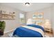 Charming bedroom decorated with blue bedding, wall art, and natural light at 8013 Toddwick Ct, Raleigh, NC 27616