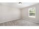 Bedroom featuring a bright window and soft neutral carpet at 8013 Toddwick Ct, Raleigh, NC 27616