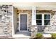 Inviting front entry with stone accents, a dark-colored door and a pillar displaying the house number at 8013 Toddwick Ct, Raleigh, NC 27616