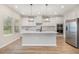 Modern kitchen features stainless steel appliances and pendant lighting at 8013 Toddwick Ct, Raleigh, NC 27616