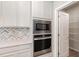 Modern kitchen includes built-in stainless microwave, oven, and pantry at 8013 Toddwick Ct, Raleigh, NC 27616