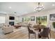 Bright living room with fireplace, plush seating, and an open dining area at 8013 Toddwick Ct, Raleigh, NC 27616