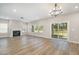 Spacious living room with fireplace, sliding glass doors, and wood-look flooring at 8013 Toddwick Ct, Raleigh, NC 27616