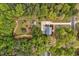 Home with a long driveway surrounded by mature trees and a backyard storage shed at 817 S Creek Dr, Nashville, NC 27856