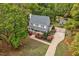 Aerial view showcasing a gray home with mature trees and a charming outdoor space with a shed at 817 S Creek Dr, Nashville, NC 27856