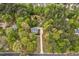 A house surrounded by mature trees and landscaping, with an outbuilding in the back at 817 S Creek Dr, Nashville, NC 27856