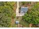 Aerial view of a home with driveway and outbuilding amid landscaped grounds and mature trees at 817 S Creek Dr, Nashville, NC 27856