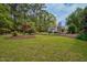 Expansive backyard features a lush green lawn and a storage building at 817 S Creek Dr, Nashville, NC 27856